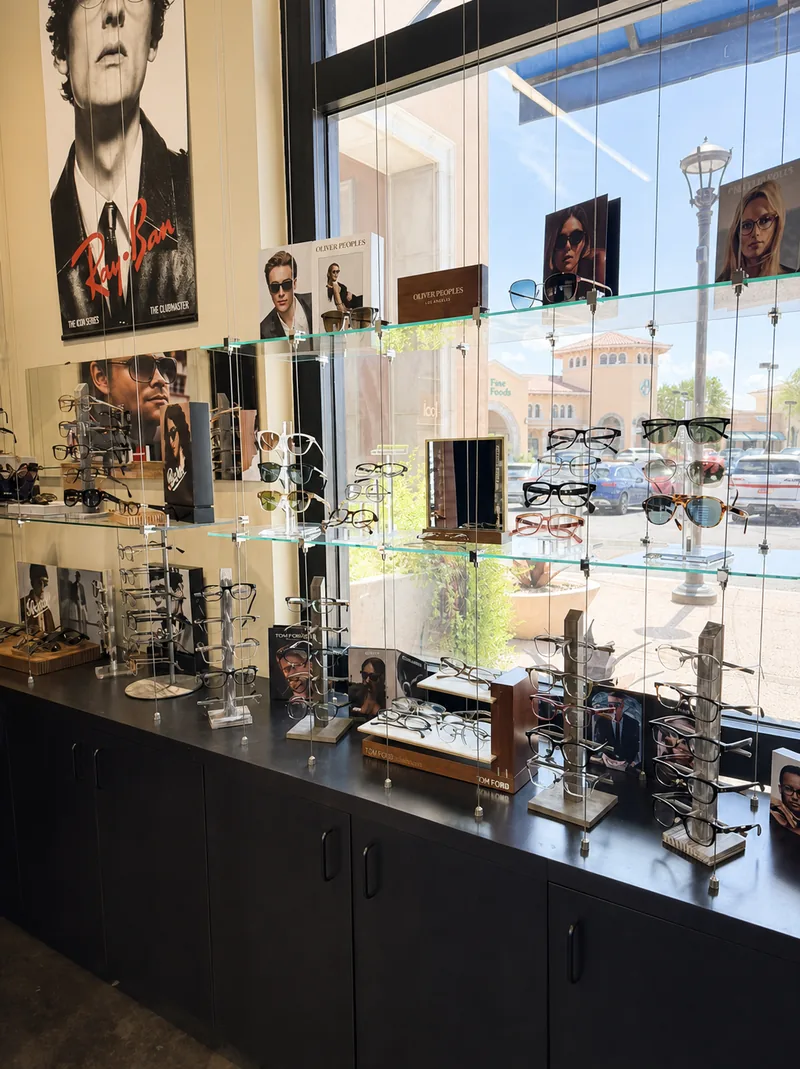 Ray-Ban sunglasses arranged on a glass display shelf along the boutique's window counter