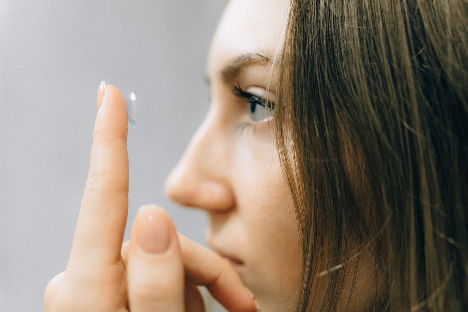 Close-up of a patient placing a contact lens — contact lens exams and fittings at Visions Optique & Eyecare, North Scottsdale